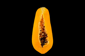 Carica Papaya On An Isolated black Background. Papaya slices, top view