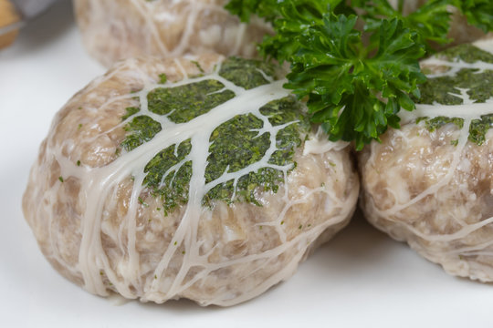 several raw crepinette on a plate