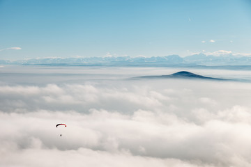 paraglider in the sky against mountains