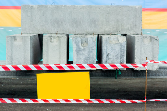 barrier fencing white and red warning tape of the danger zone of the test of block panels under load for deflection.