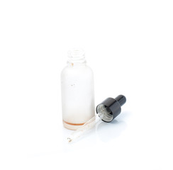 Empty transparent vape liquid bottle with residue isolated on the white background