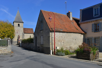 Fototapeta na wymiar Rue Armand Guillaumin (D72) depuis l'église à Crozant (23160), département de la Creuse en région Nouvelle-Aquitaine, France