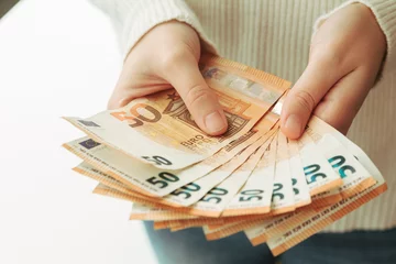Fotobehang Stock photo of some hands showing money © AdriaVidal