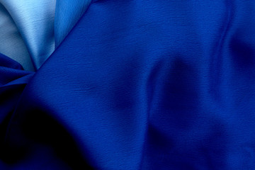 Abstract classic blue background draped silk fabric.