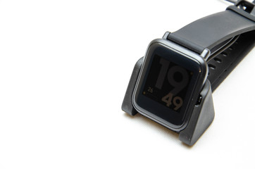 Smart watch on hand. Smart watch on a white background. Charger for smart watches. Dock station. Men's hands hold a smart watch and put them on charge. Watch, charger in close-up