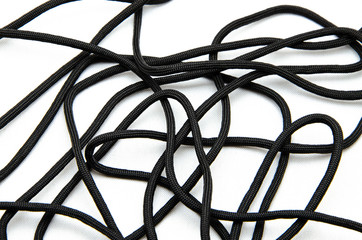 Rope Paracord. Paracord for weaving and tourism. Safety rope rope. Black tactical paracord on a white background and in the hands