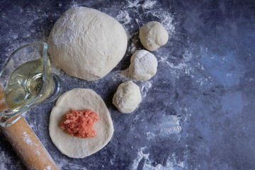 The process of making meat pies from dough with alternative gluten-free flour. Delicious homemade cakes. Slow baking, a useful home product. Copy space. Top view.