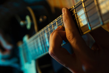 Man's hands play the guitar