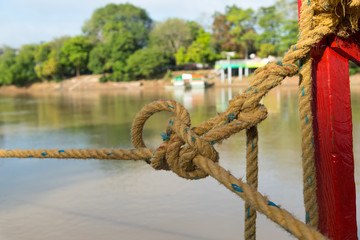 Fototapeta premium Rope moored from a small pier in a Colombian river