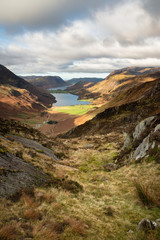 Naklejka na ściany i meble Majestic vibrant Autumn Fall landscape of Buttermere and Crummock Water flanked by mountain peaks of Haystacks High Stile and Mellbreak in Lake District