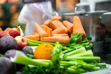 Juice Bar with assorted fresh fruits and vegetables. Tropical summer outdoor background.Various vegetables on the counter. organic fresh fruits and vegetables on grocery counter.Detoxification concept