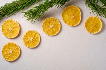 Fototapeta na wymiar Creative holiday Christmas New Year food fruit texture with dried orange with branch of fir tree macro, top view, white background copy space