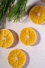 Fototapeta na wymiar Creative holiday Christmas New Year food fruit texture with dried orange with branch of fir tree macro, top view, white background with shadow