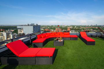 View of city from the top. Relaxing zone on the rooftop terrace.