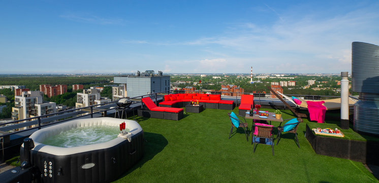 Rooftop with relax zone in modern living complex. Oudor hot jakuzzi and cozy furniture.