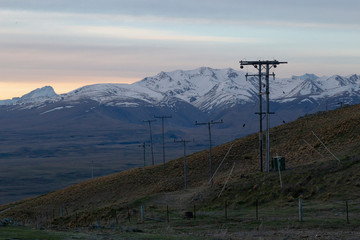 High voltage electric power line in the foreground. Majestic New Zealand alps on the background. Tekapo, New Zealand.