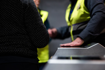 Security guard in subway station. Guard checking an automatic ticket machine at a metro station.
