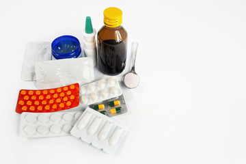 Various preparations for the treatment of colds and flu on a white background