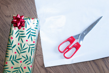 Christmas gift packages, wrapping gifts for the holiday season. make gifts in package with colored paper and bows on a work table