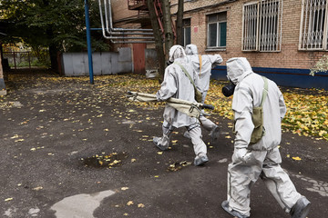 The next rescue team with a stretcher goes to an infection zone for evacuation of victims