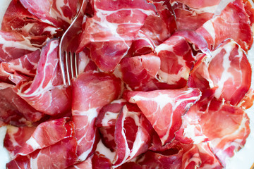 Italian aperitif during the holidays. ham and loin cut into slices and served in a serving dish....