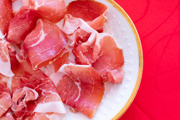 Italian aperitif during the holidays. ham and loin cut into slices and served in a serving dish. Seasoned Italian ham, cuisine and appetizer for a typical lunch. Delicatessen slices and desire to eat