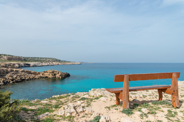 Wooden bench on the observation point at the small bay
