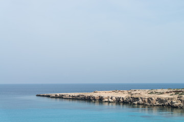 Curved rocky seashore and transparent water of Mediterranean sea