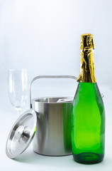 Metal cooler with lid, tongs and champagne with glasses ready to serve
