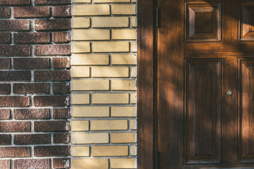 Vintage brown yellow brick wall wood door background texture