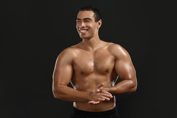 Fototapeta premium Sporty African-American man on dark background