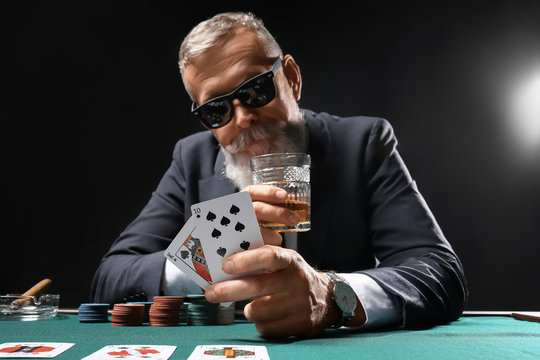 Mature businessman playing in casino