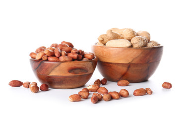 Bowls with peanuts on white background