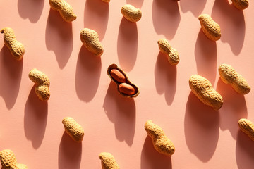 Tasty peanuts on color background