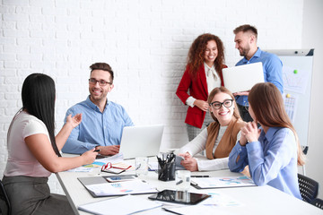 Fototapeta premium Colleagues discussing issue at business meeting in office
