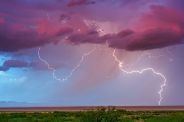 Thunderstorm lightning bolt strike with storm clouds