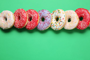 Sweet tasty donuts on color background