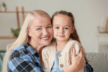 Little girl and grandmother spending time together at home