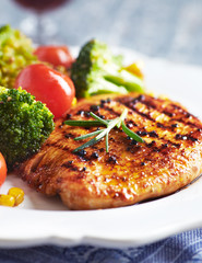 Grilled Turkey Breast with oven baked broccoli. Close up.