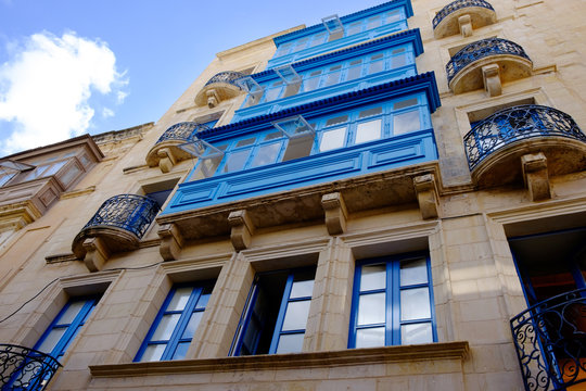 View on a house with blue balconies in Valletta, Malta.