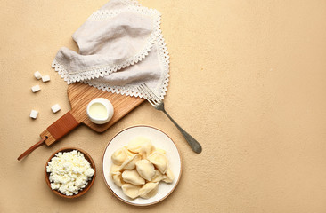 Composition with tasty dumplings and quark on color background