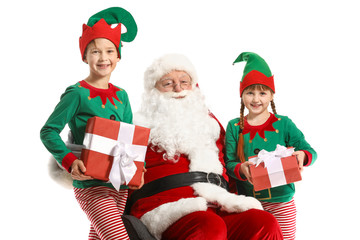 Santa Claus and little elf kids with gifts on white background