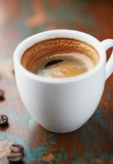 Cup of coffee on brown background. Close up.