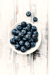 Bilberries on white wooden background. Top view. 
