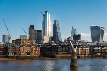 Tall Buildings in City of London Financial District and the Millennium Bridge Crossing Thames River