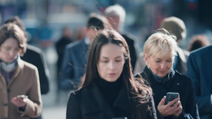 Diverse and Multicultural Office Managers and Business People Commute to Work or from Office on Foot. Pedestrians Use Devices. Successful People Walking in Downtown. Soft Moving Focus.