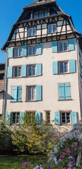 White timber framed house with blue shutters in Strasbourg, France