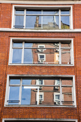Brick building reflection on windows