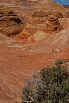 A Group Of Hikers Enjoying The Awe Inspiring Beauty Of The Wave In Northern Arizona.