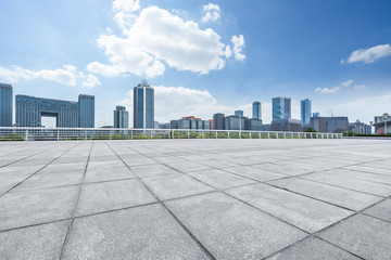 Panoramic skyline and buildings with empty square floor.